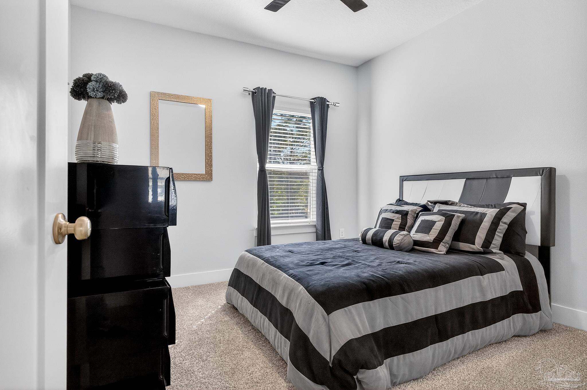 6076 Rutherford Loop Pensacola, FL 32526 - Photo 36 of 67 a bedroom with a bed and a window