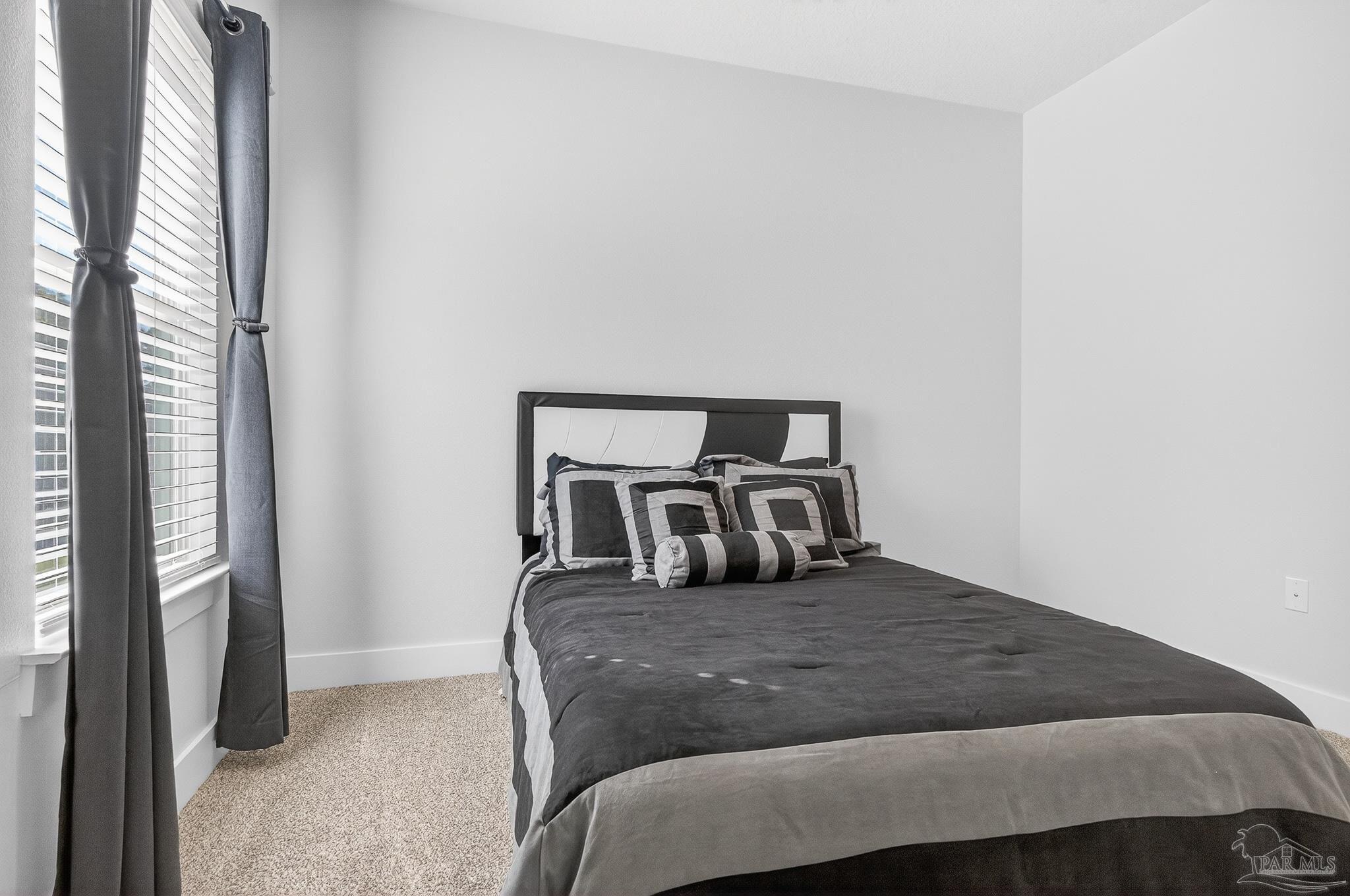 6076 Rutherford Loop Pensacola, FL 32526 - Photo 37 of 67 a bedroom with a bed and large window