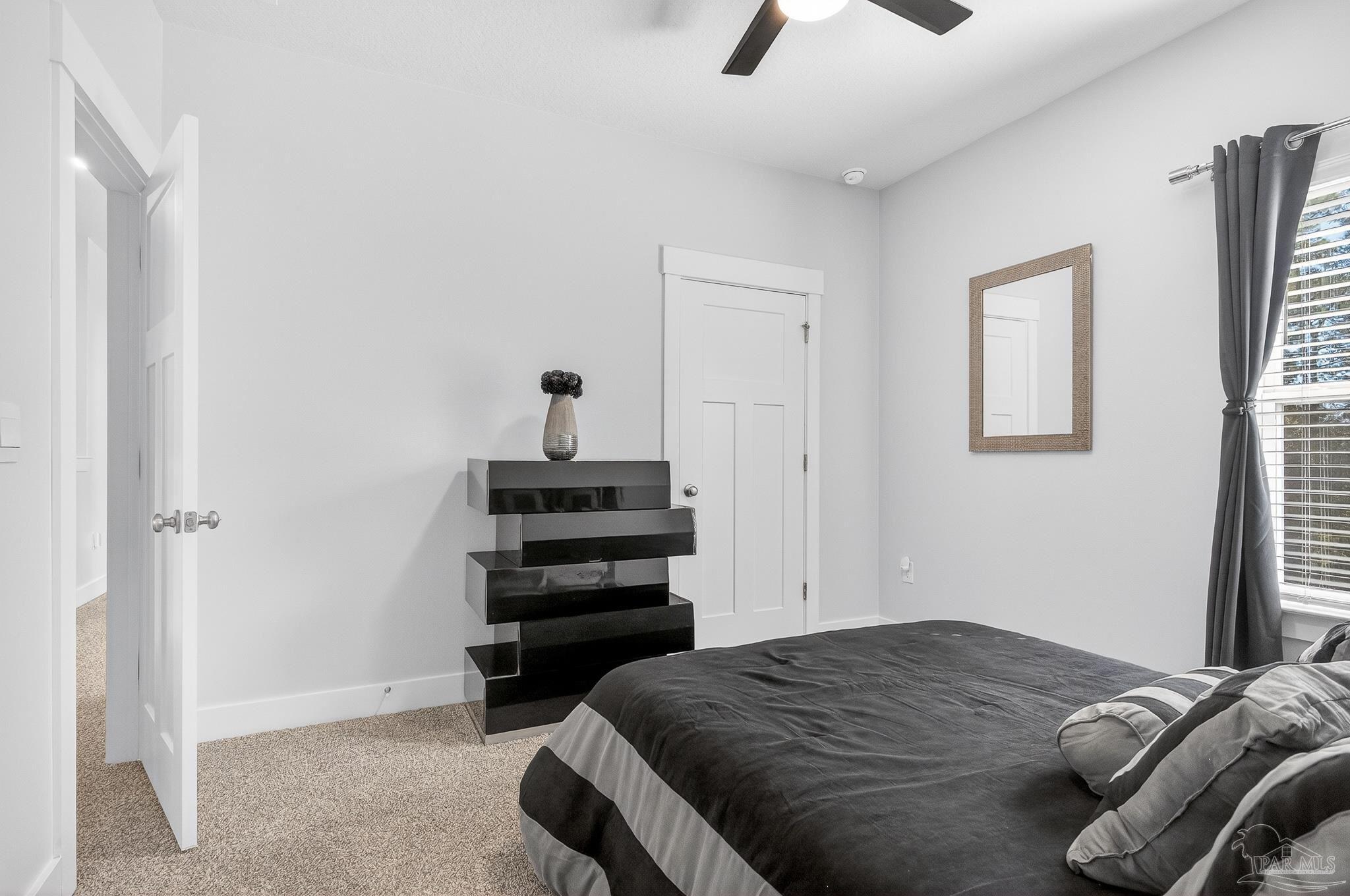 6076 Rutherford Loop Pensacola, FL 32526 - Photo 38 of 67 a bedroom with a bed and a ceiling fan