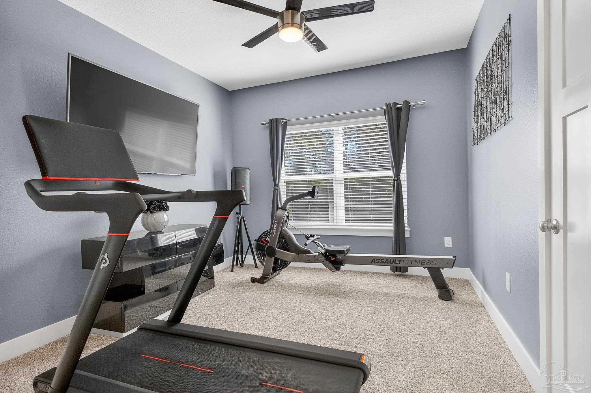 6076 Rutherford Loop Pensacola, FL 32526 - Photo 40 of 67 a room with gym equipment and a large window