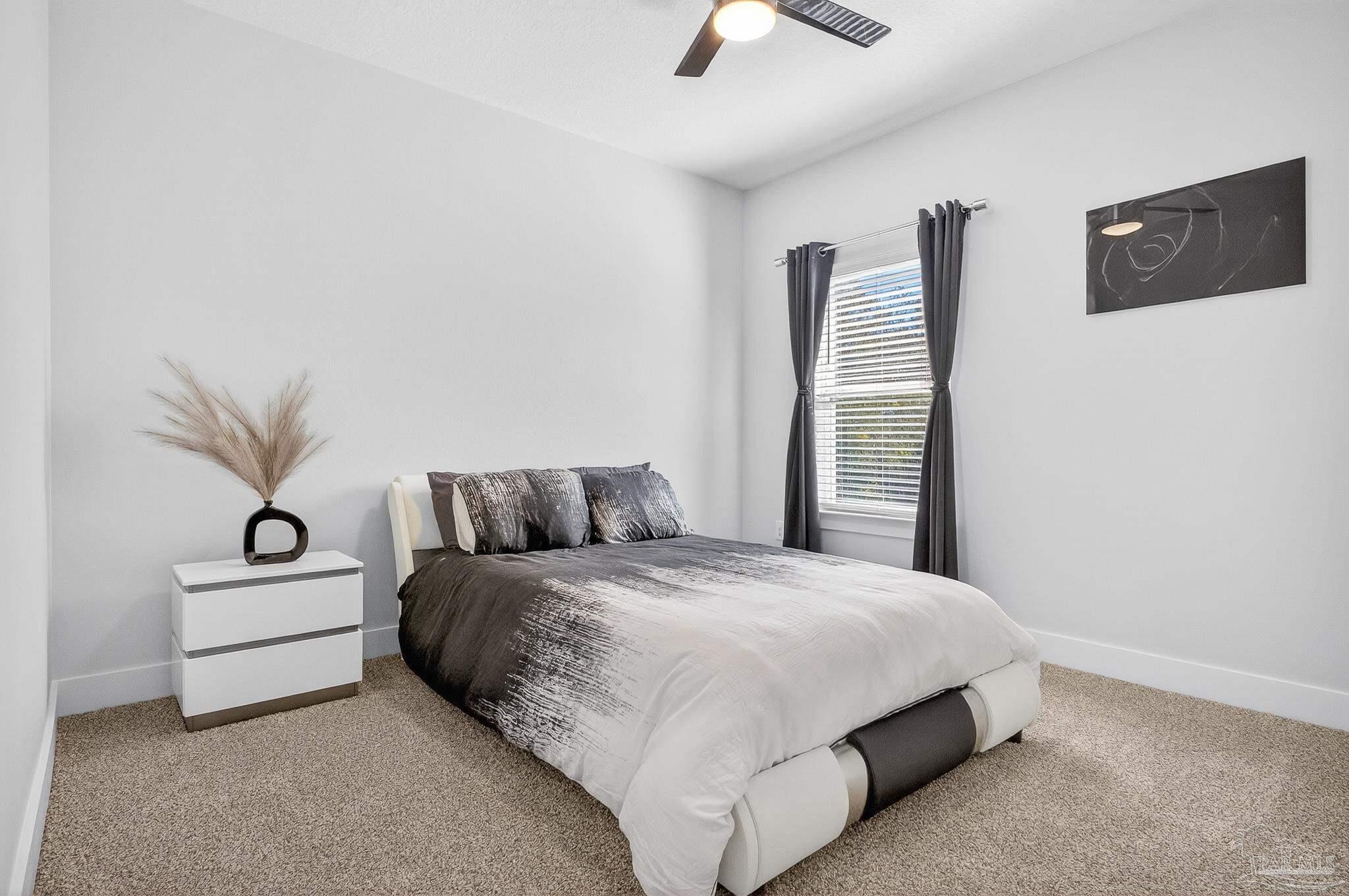 6076 Rutherford Loop Pensacola, FL 32526 - Photo 43 of 67 a bedroom with a bed and a night stand