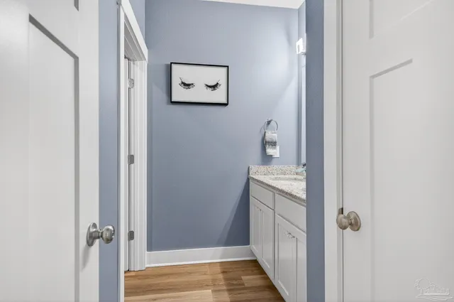a bathroom with a granite countertop tub sink and mirror