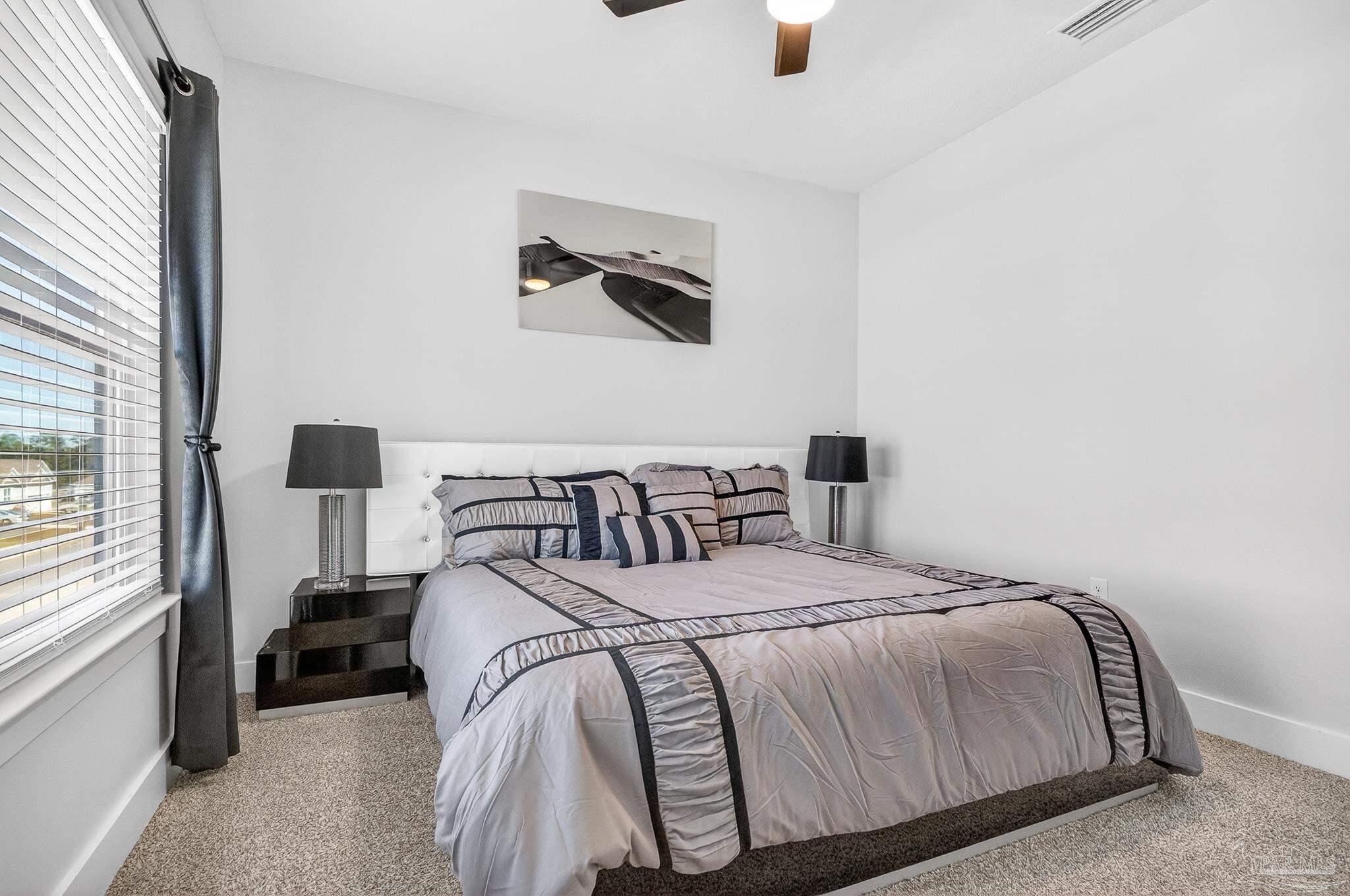 6076 Rutherford Loop Pensacola, FL 32526 - Photo 54 of 67 a bedroom with a bed and a window