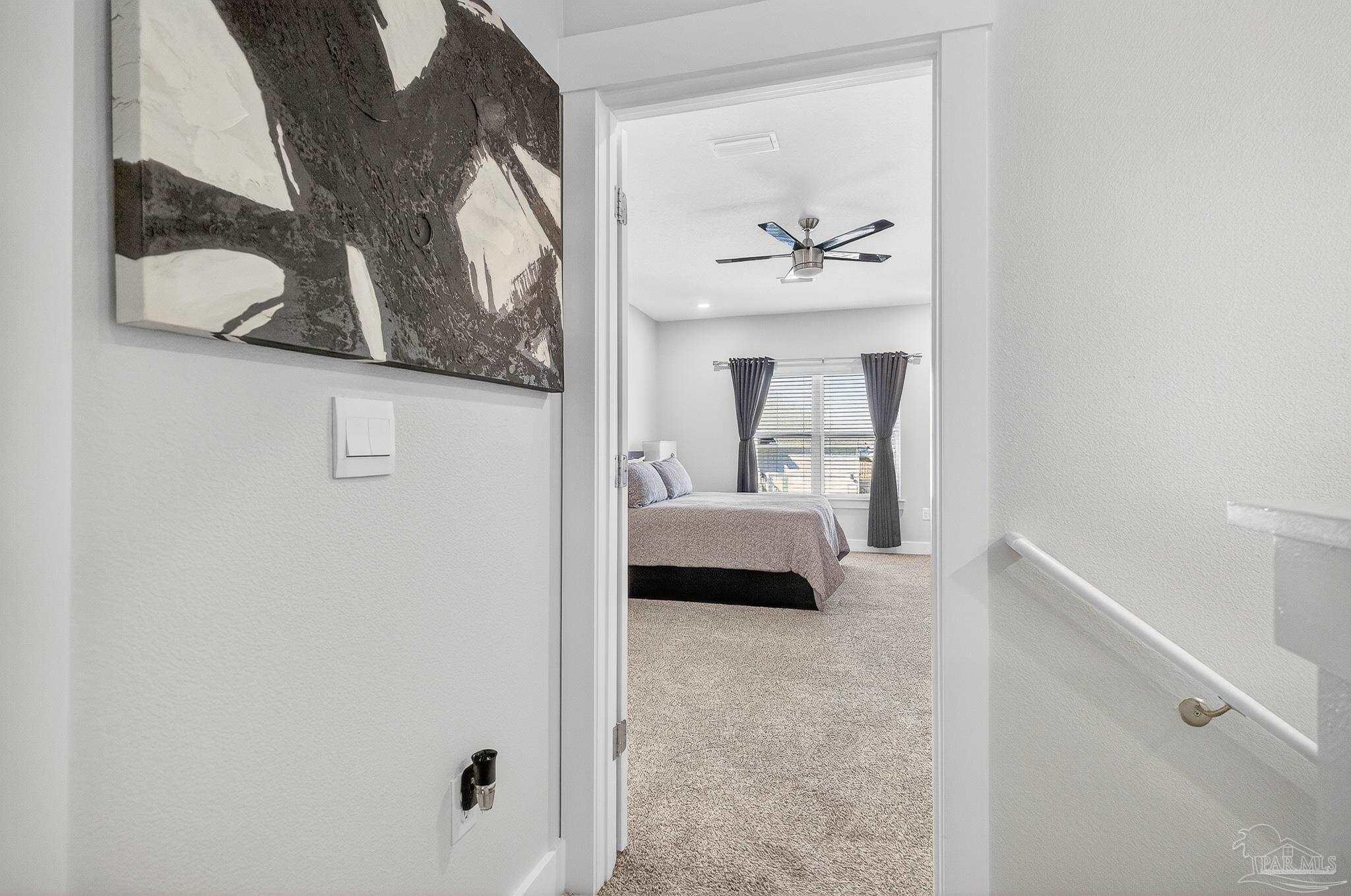 6076 Rutherford Loop Pensacola, FL 32526 - Photo 59 of 67 a view of a bedroom with a large bed and a mirror