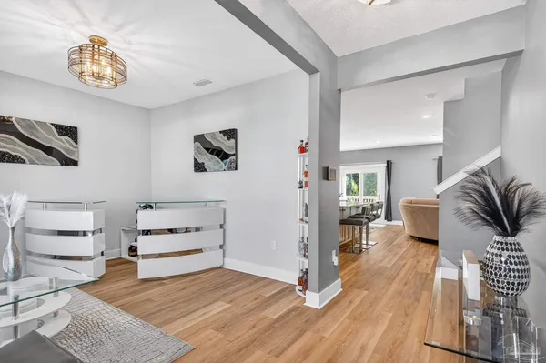a living room with furniture a rug and white walls