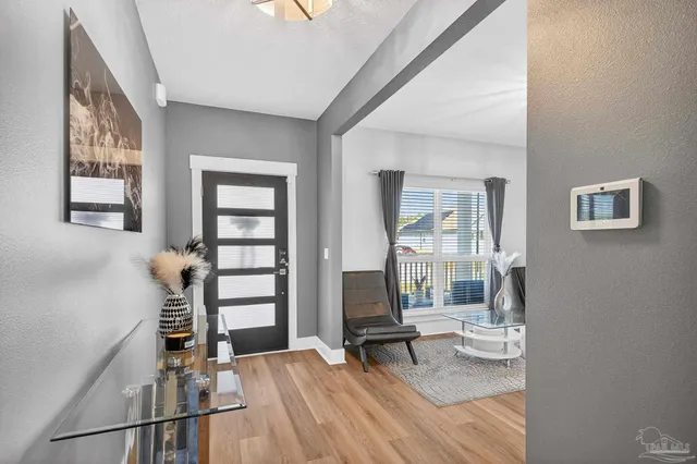 a open kitchen with white cabinets and stainless steel appliances