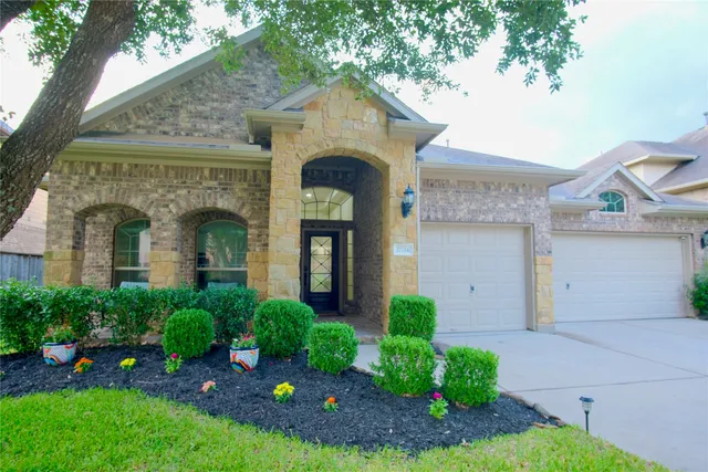 a front view of a house with garden