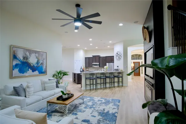 a living room with furniture and a painting on the wall