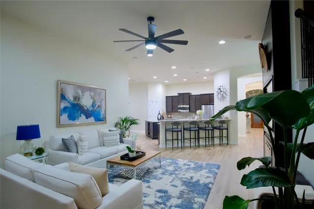 a living room with furniture and a potted plant