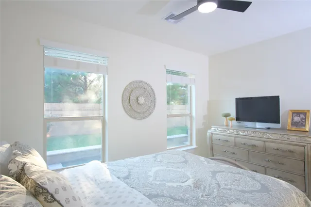 a bedroom with a bed and a television