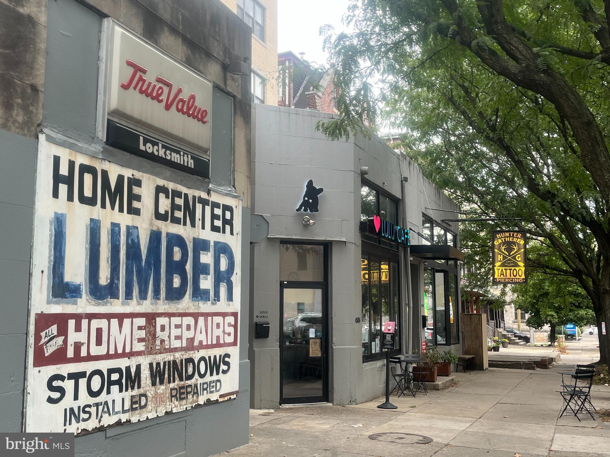 4508 Walnut Street, Unit 302 Philadelphia, PA 19139 - Photo 14 of 14 a view of tall building with retail shops and traffic signal