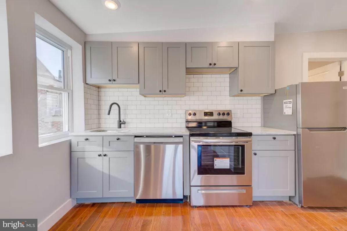 4508 Walnut Street, Unit 302 Philadelphia, PA 19139 - Photo 7 of 14 a kitchen with cabinets appliances and a window
