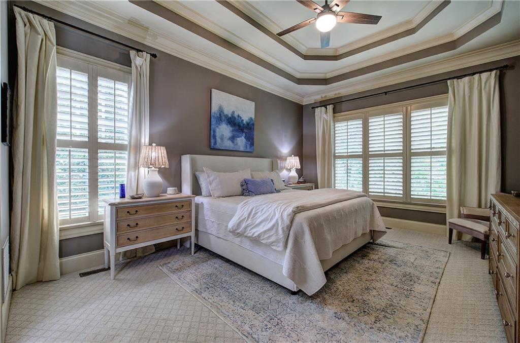 16 Cambridge Way Cartersville, GA 30121 - Photo 18 of 48 a spacious bedroom with a bed a chandelier and large window