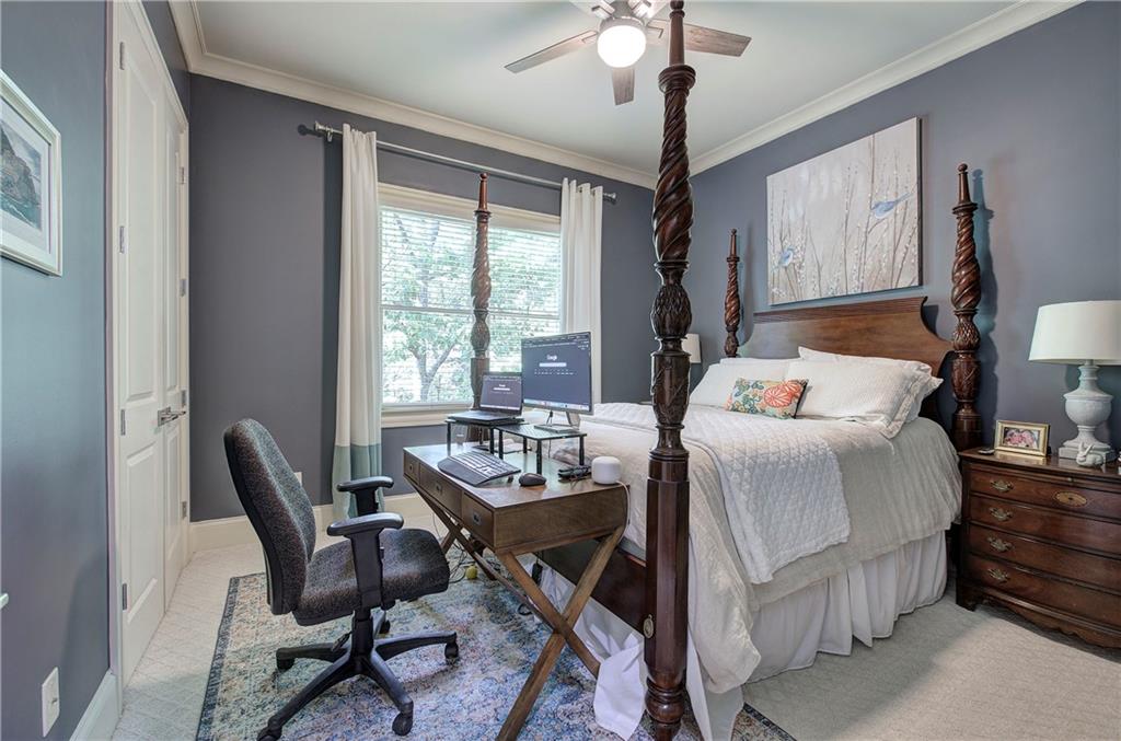 16 Cambridge Way Cartersville, GA 30121 - Photo 22 of 48 a bedroom with a bed a desk and chair with wooden floor