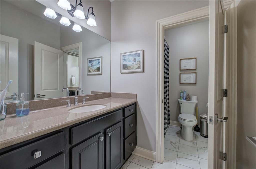 16 Cambridge Way Cartersville, GA 30121 - Photo 32 of 48 a bathroom with a granite countertop sink a toilet and a mirror