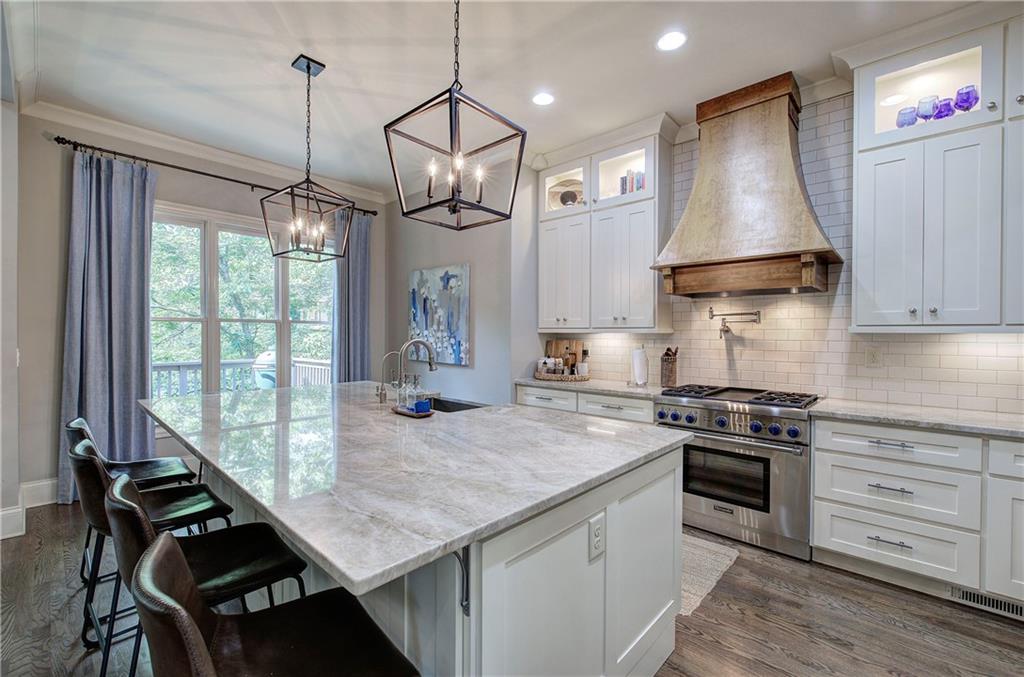 16 Cambridge Way Cartersville, GA 30121 - Photo 10 of 48 a kitchen with a stove a sink a window and wooden floor