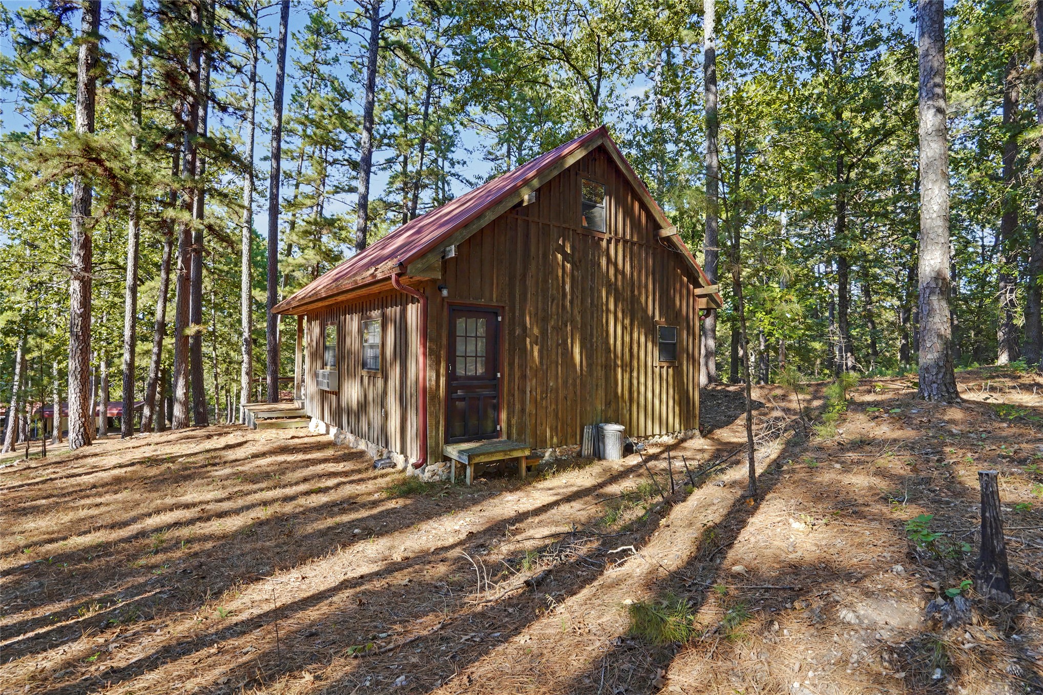 46420 South 590 Road Jay, OK 74346 - Photo 26 of 63 Wood-sided cabin featuring a red metal roof and natural wood steps