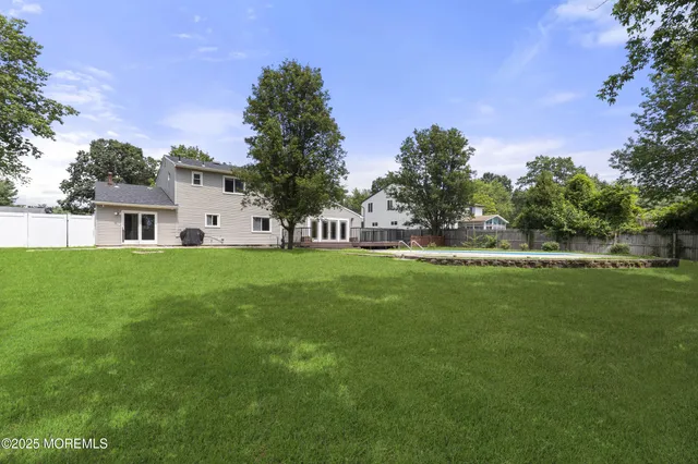 a house view with garden space and trees