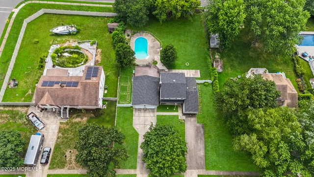 an aerial view of a house with outdoor space pool seating area and yard