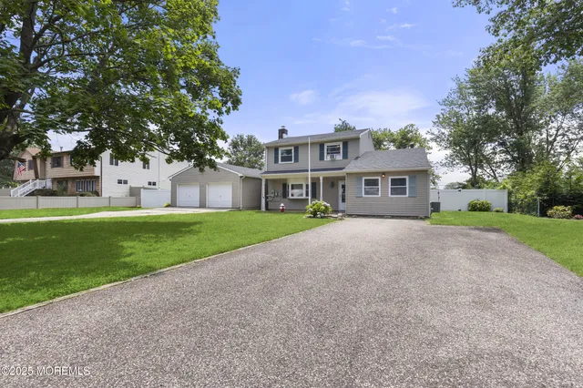a front view of house with yard and green space