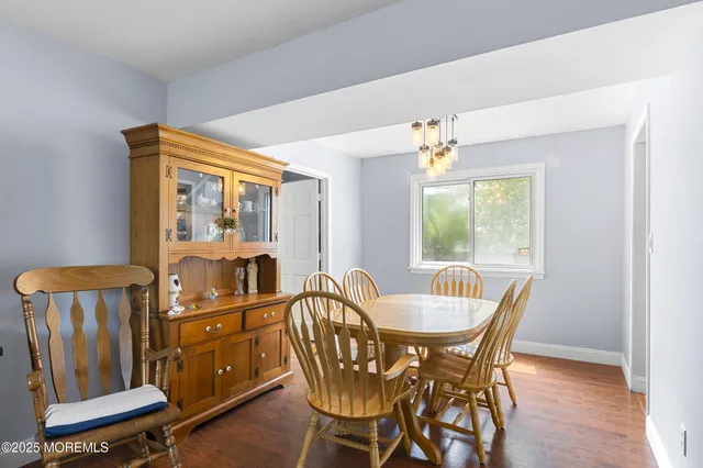 a view of a dining room with furniture and a window