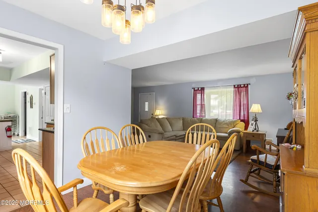 a view of a dining room with furniture and chandelier