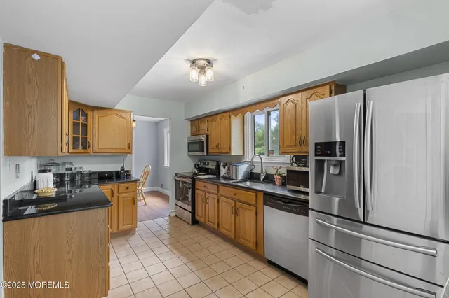 a kitchen with stainless steel appliances granite countertop a stove top oven a sink and dishwasher
