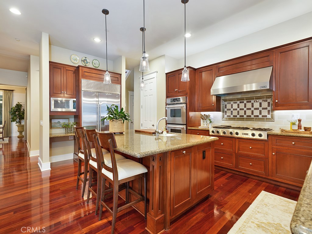 28291 Williams Canyon Road Silverado, CA 92676 - Photo 21 of 74 a kitchen with stainless steel appliances granite countertop wooden floors stove and white cabinets