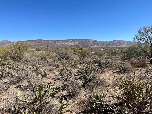 a view of a mountain range with lush green forest