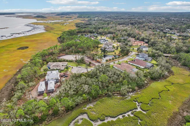 an aerial view of a house with a yard swimming pool and outdoor seating
