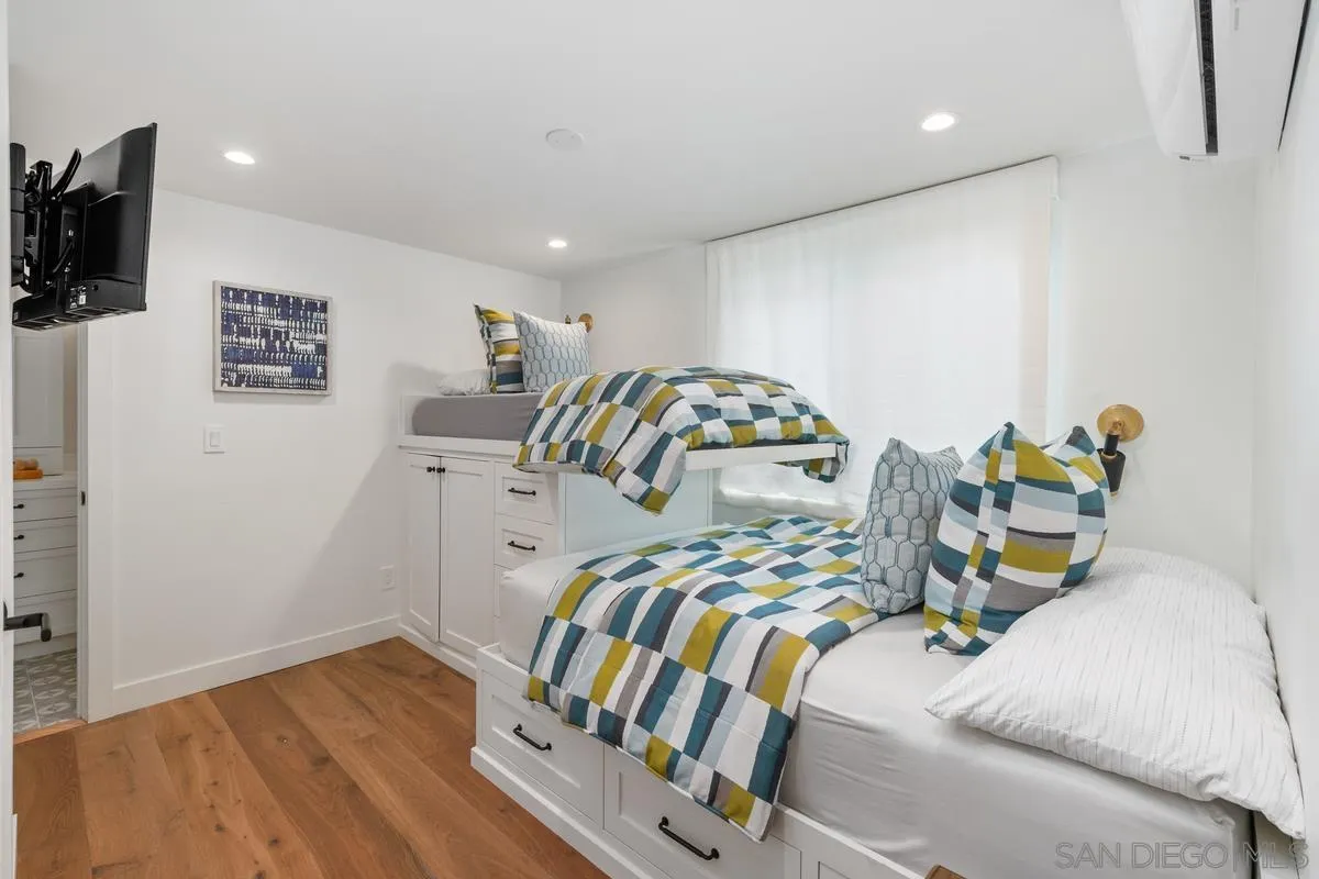 123 Jasper Street, Unit 29 Encinitas, CA 92024 - Photo 12 of 19 a bedroom with a bed and a tv on the dresser