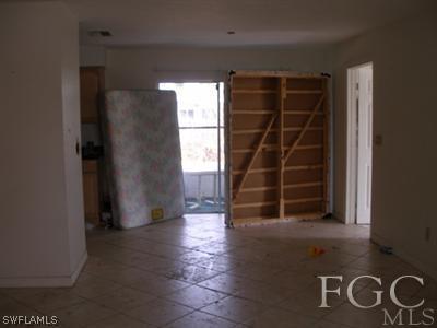 7317 Jonas Road Fort Myers, FL 33967 - Photo 3 of 10 a view of an empty room with wooden floor and windows