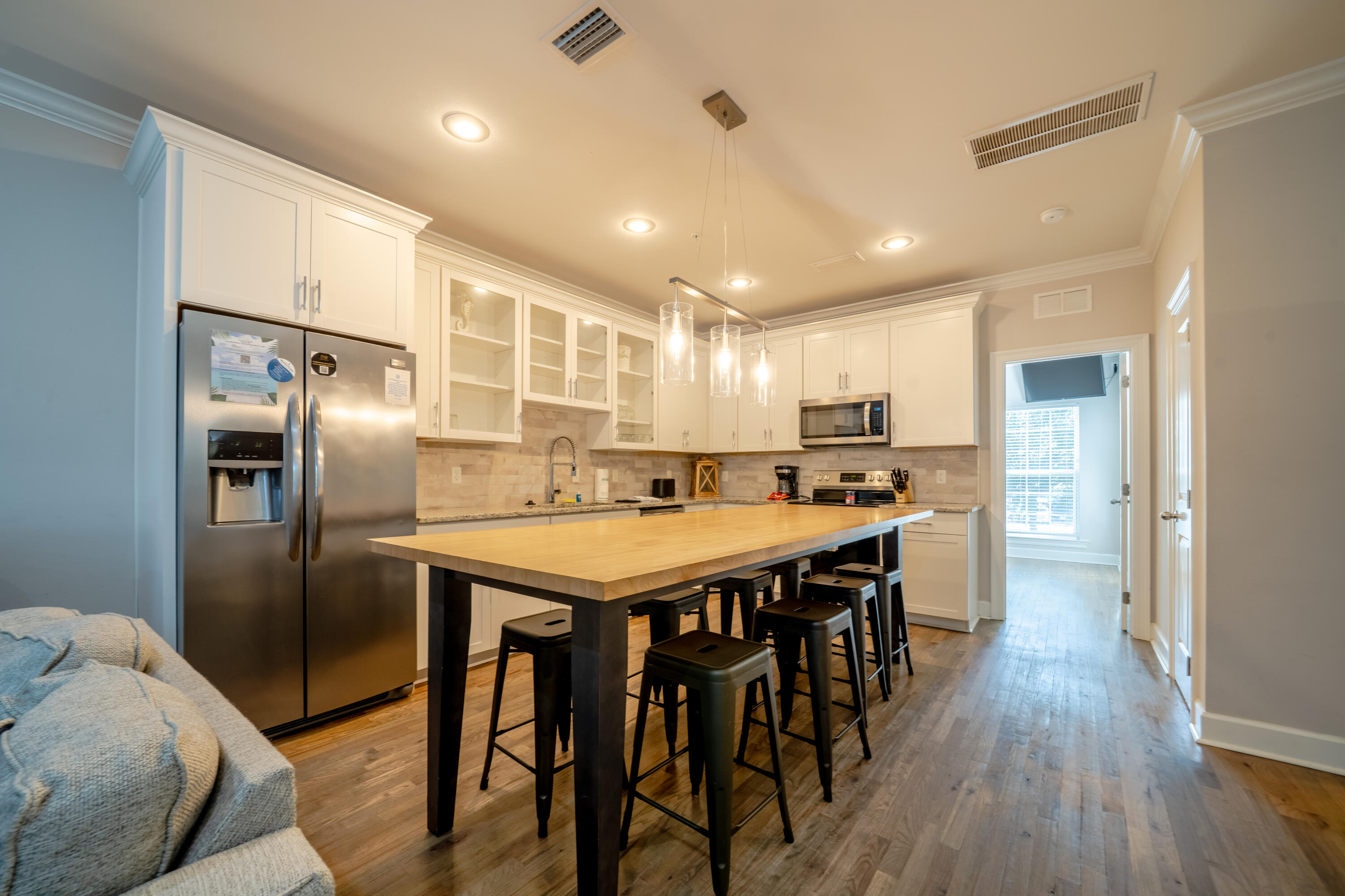 257 Driftwood Road, Unit 2 Miramar Beach, FL 32550 - Photo 14 of 35 a kitchen with stainless steel appliances granite countertop a table chairs sink refrigerator and cabinets