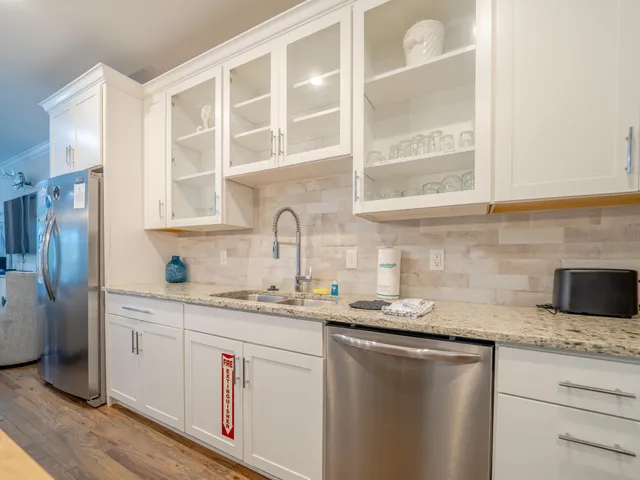 a kitchen with stainless steel appliances granite countertop a sink and a granite counter tops