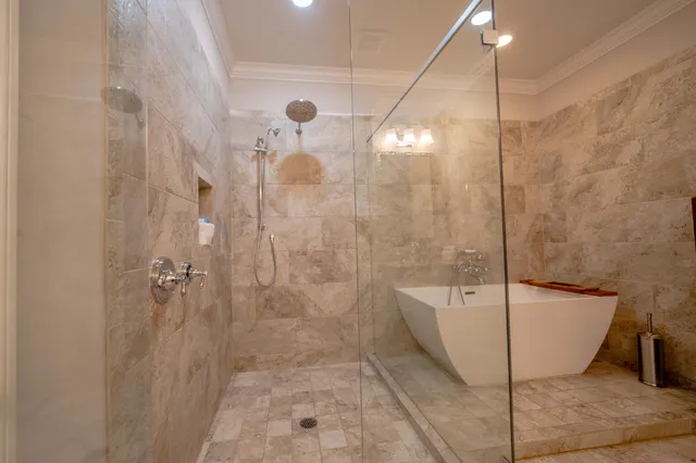 a bathroom with a bathtub and shower