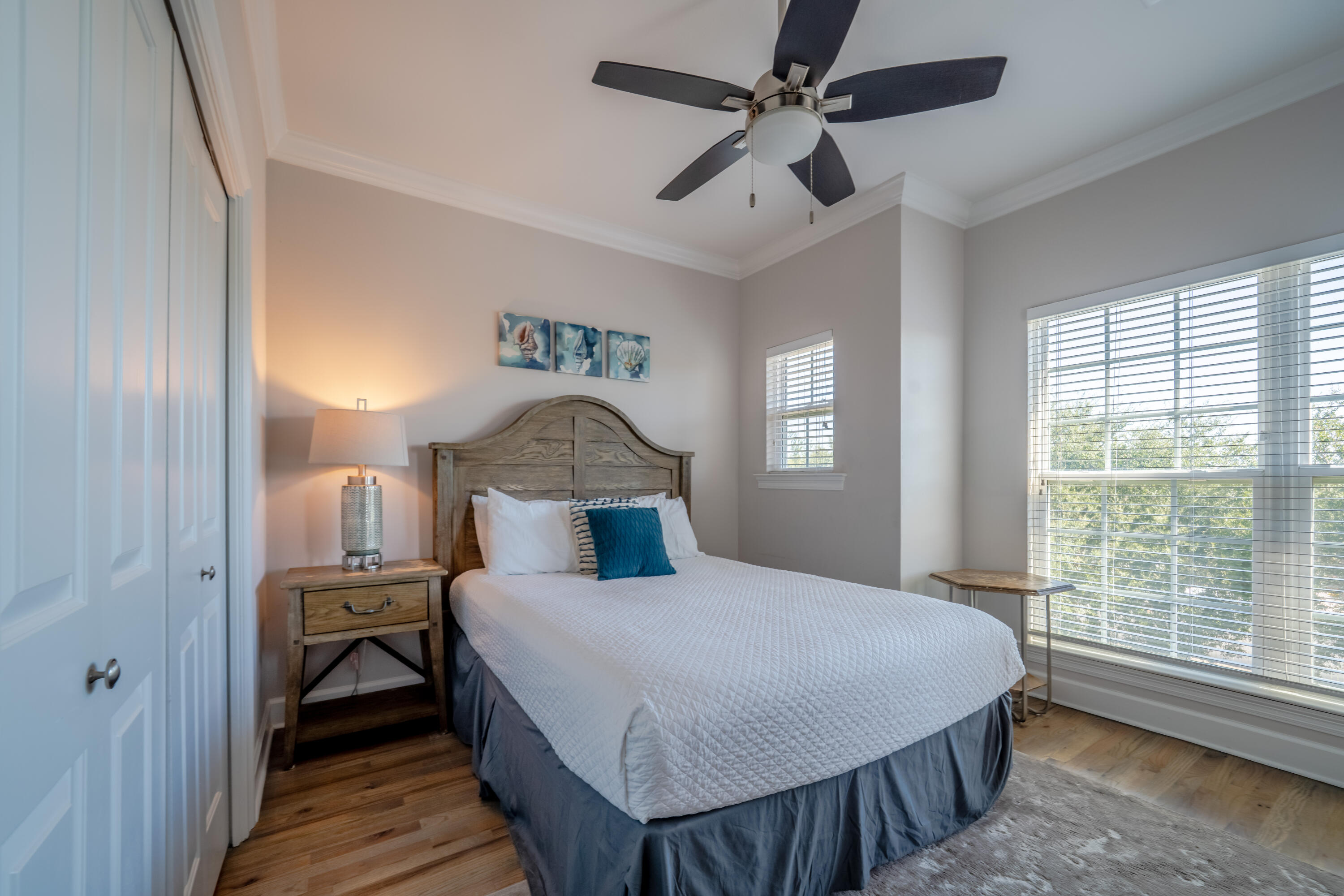 257 Driftwood Road, Unit 2 Miramar Beach, FL 32550 - Photo 30 of 35 a bedroom with a bed a chandelier and a window