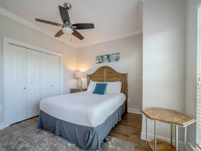 a bedroom with a bed and a ceiling fan