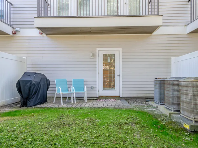a view of a backyard with plants and outdoor seating