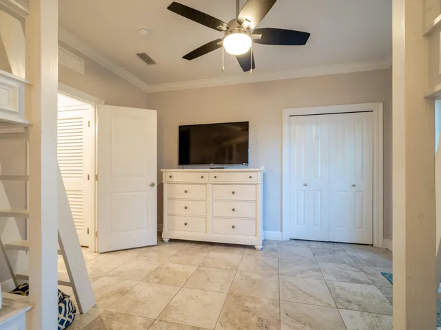 a view of room with flat screen tv and ceiling fan