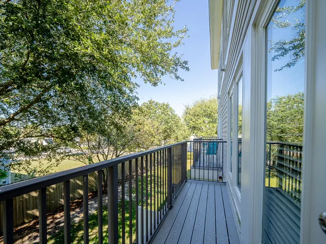 a view of a balcony with wooden floor