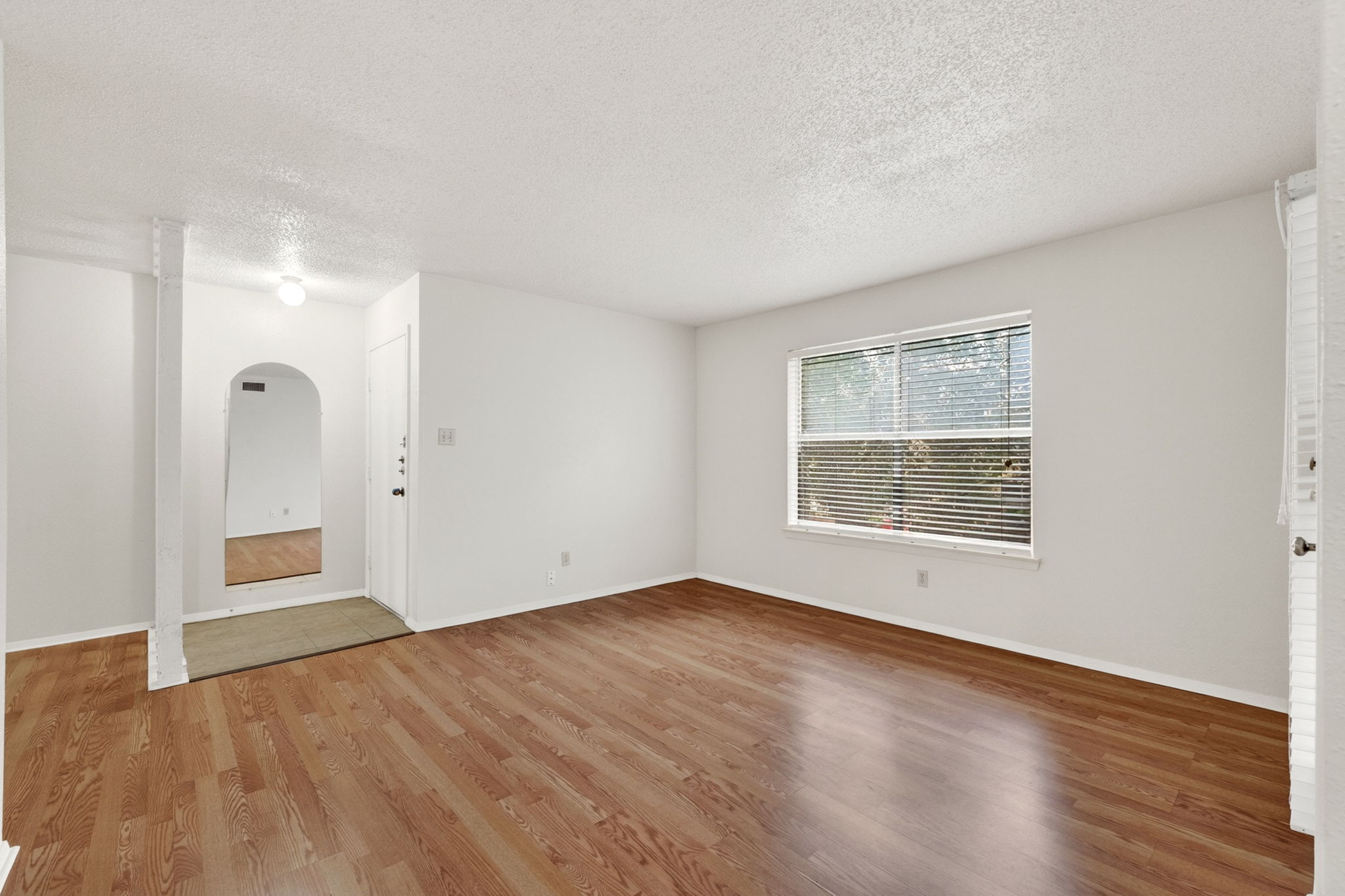 8210 Bent Tree Road, Unit 256 Austin, TX 78759 - Photo 7 of 29 an empty room with wooden floor and windows