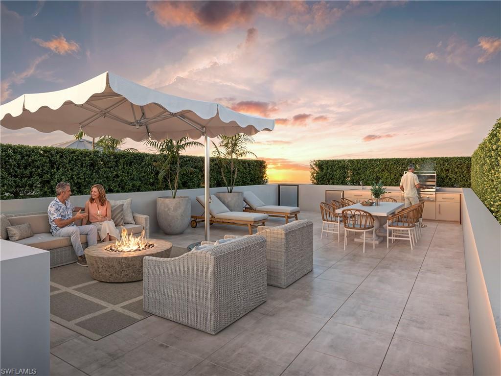 a view of a terrace with furniture and a garden