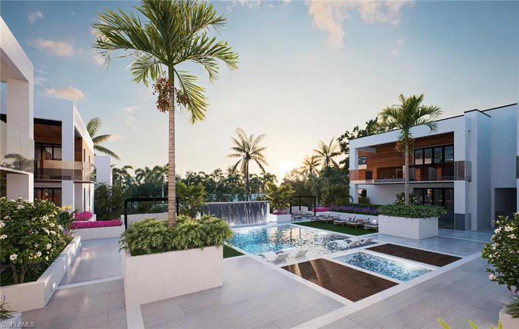 210 9th Street South, Unit 201 Naples, FL 34102 - Photo 3 of 6 a view of a backyard with couches under an umbrella