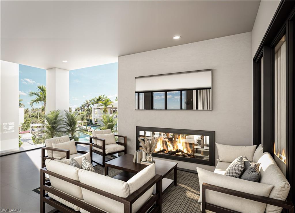 210 9th Street South, Unit 201 Naples, FL 34102 - Photo 6 of 6 a living room with furniture and a fireplace