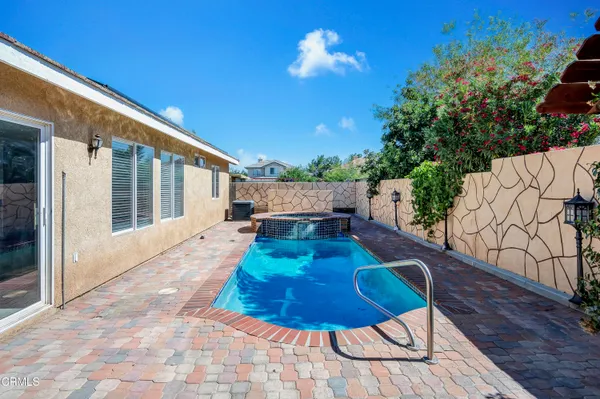 a view of a house with backyard and sitting area