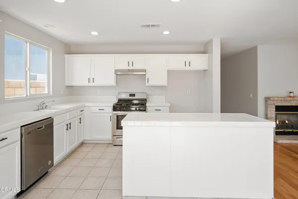 a kitchen with cabinets and white appliances