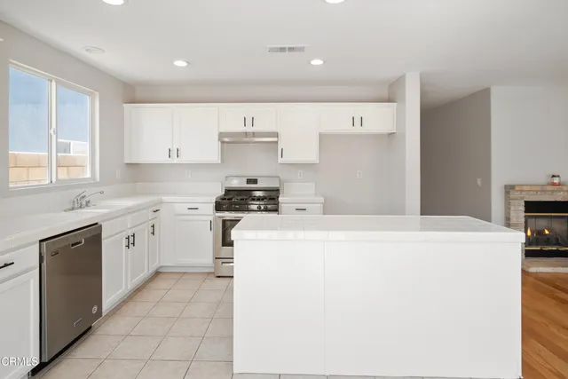 a kitchen with cabinets and white appliances