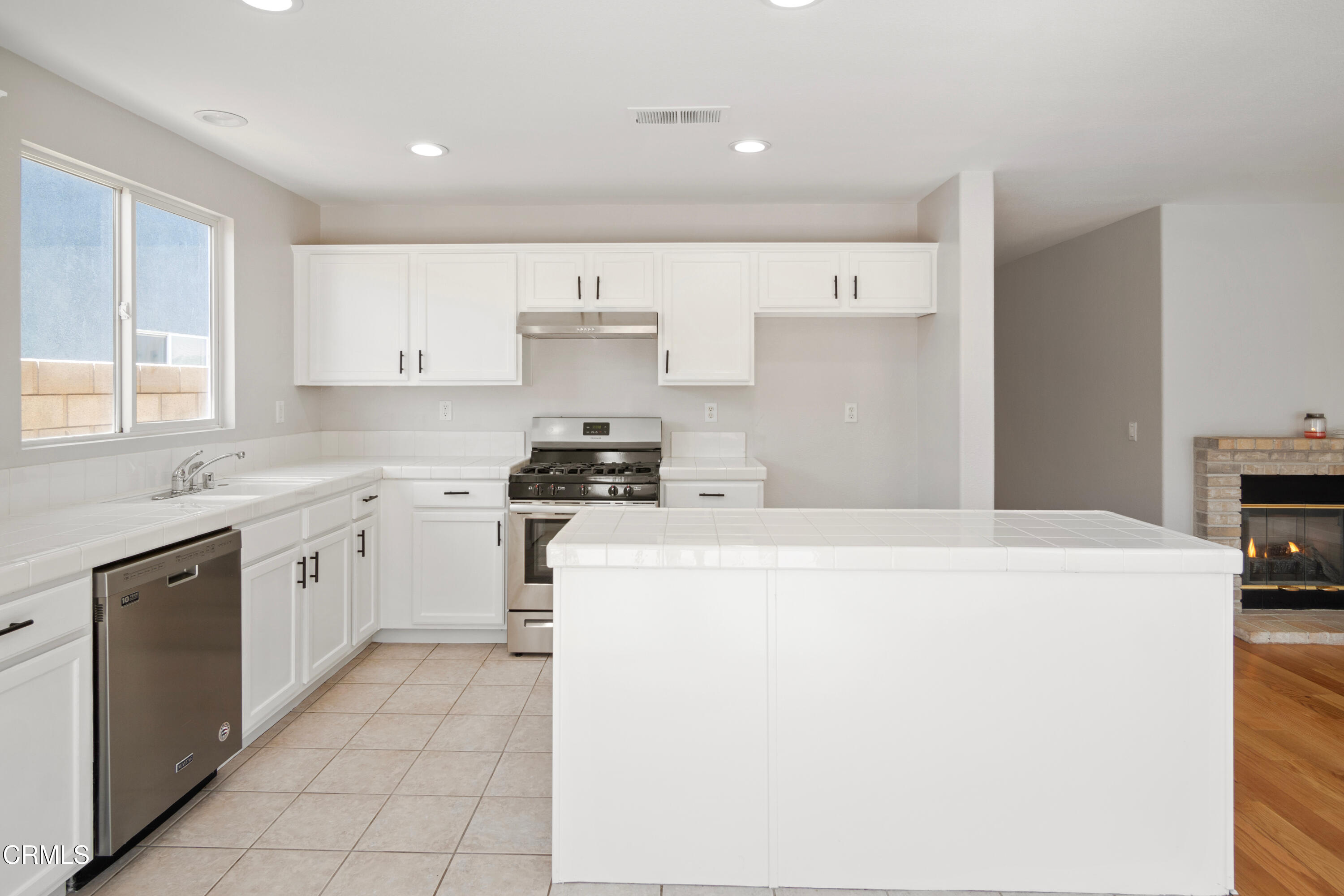 45736 17th Street West Lancaster, CA 93534 - Photo 3 of 6 a kitchen with cabinets and white appliances