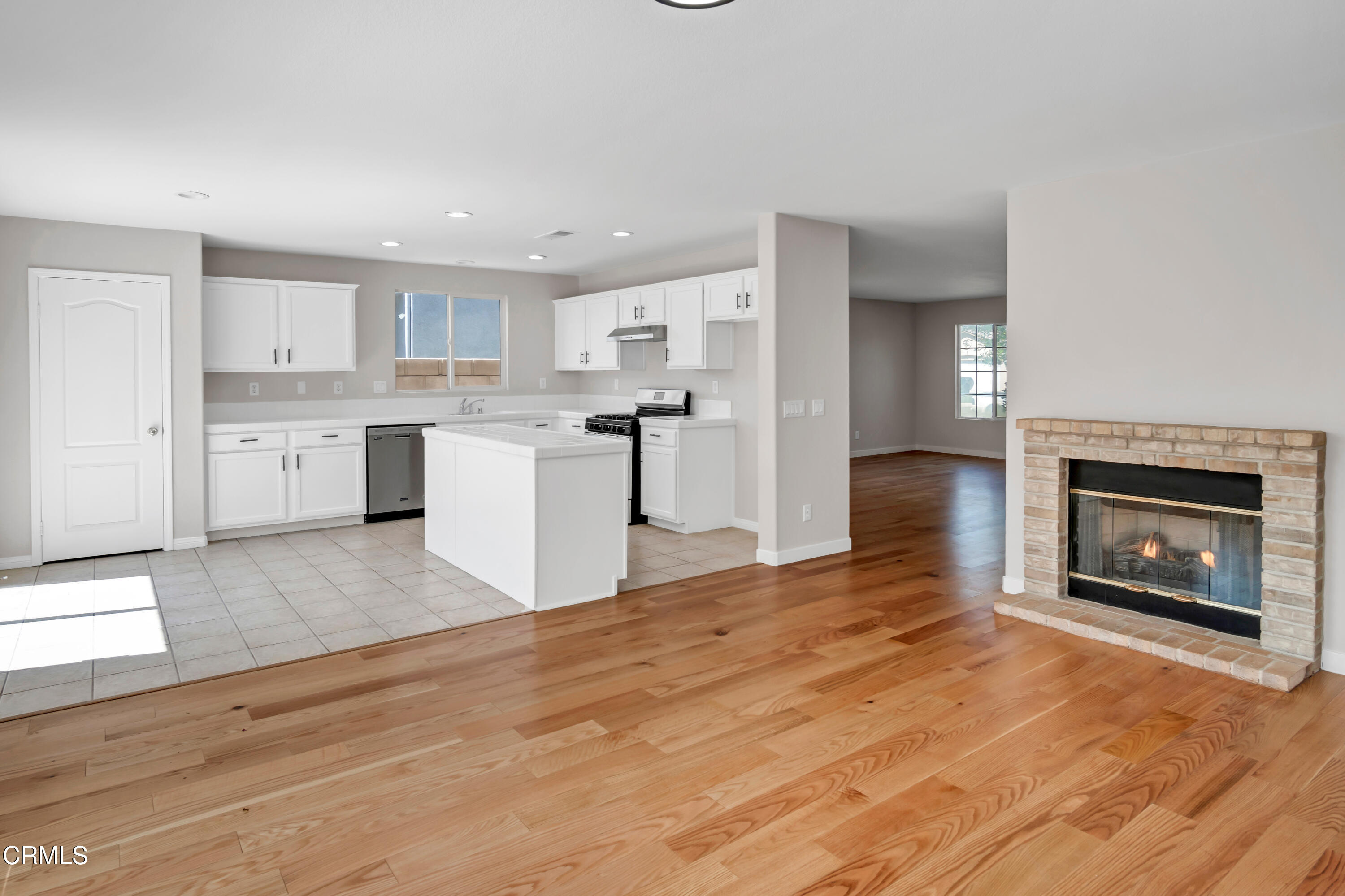 45736 17th Street West Lancaster, CA 93534 - Photo 4 of 6 a large kitchen with kitchen island a sink stainless steel appliances and cabinets