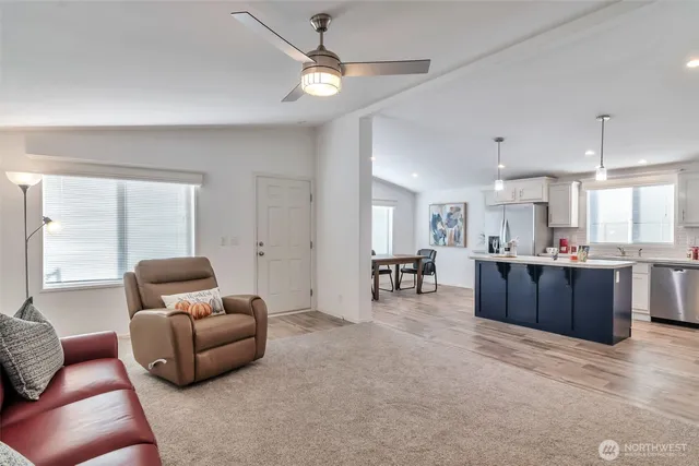 a living room with furniture and kitchen view